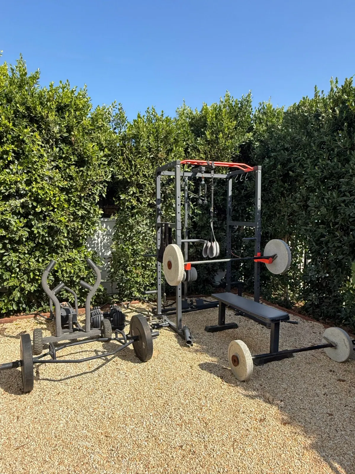 Outdoor gym with power rack, bench and barbells