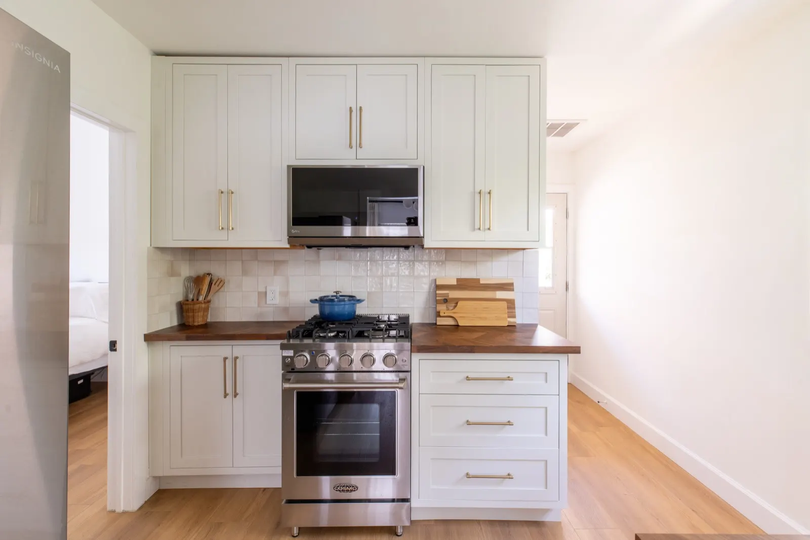 Kitchen with gas range and walnut counters