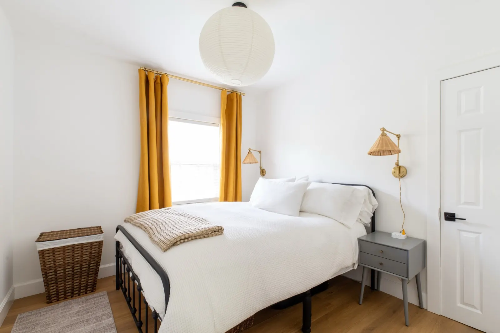 Second bedroom with queen bed and marigold curtains